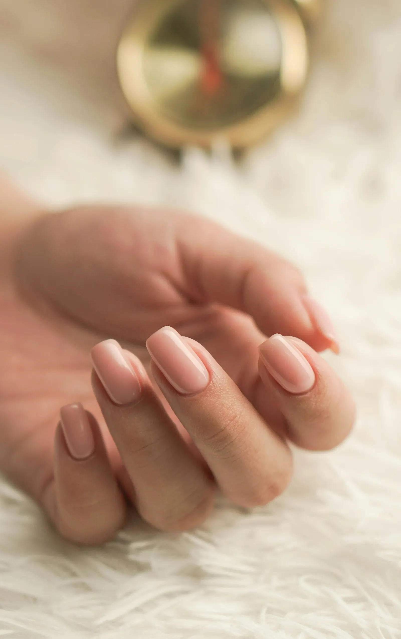 Hands with soft pink gel manicure